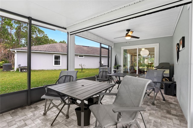 sunroom featuring ceiling fan