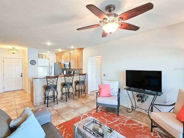 living room with light tile patterned floors and ceiling fan