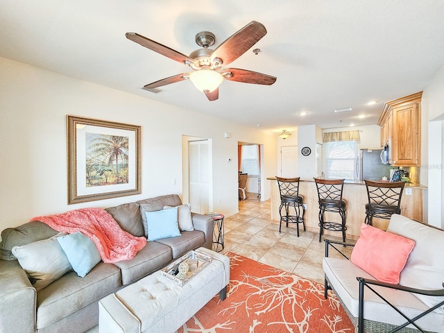 tiled living room with ceiling fan