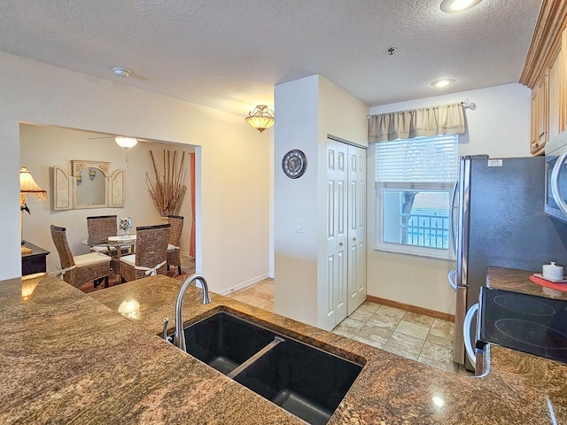 kitchen featuring sink, a textured ceiling, and appliances with stainless steel finishes