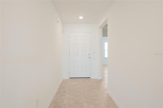 corridor featuring light tile patterned floors