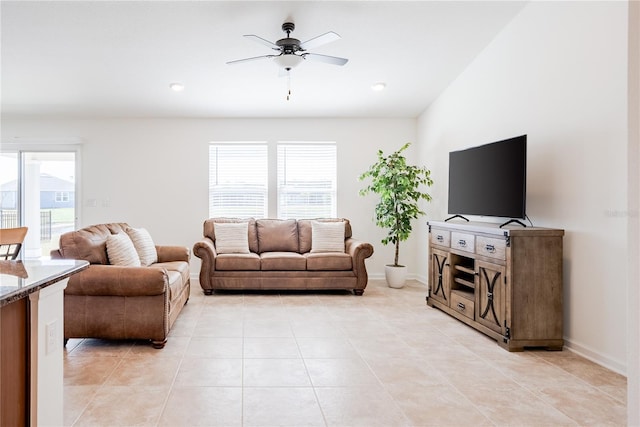 living room featuring ceiling fan and light tile patterned flooring