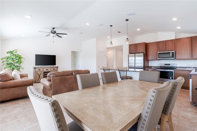 dining space featuring lofted ceiling, light tile patterned floors, and ceiling fan