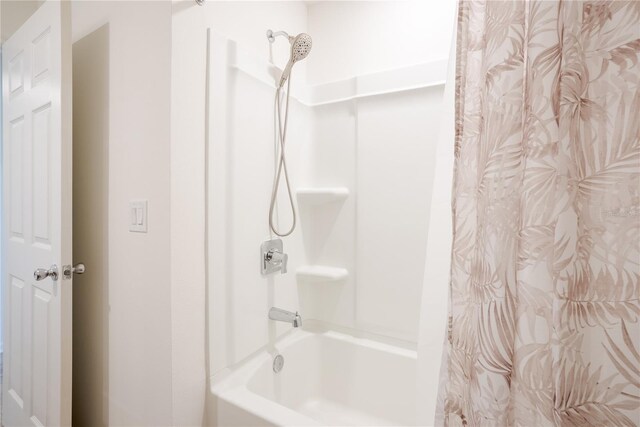 bathroom with shower / bath combo with shower curtain