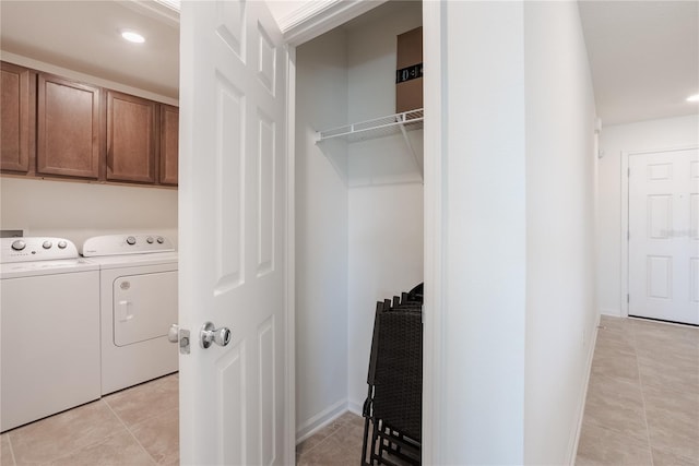 laundry area featuring cabinets, separate washer and dryer, and light tile patterned floors