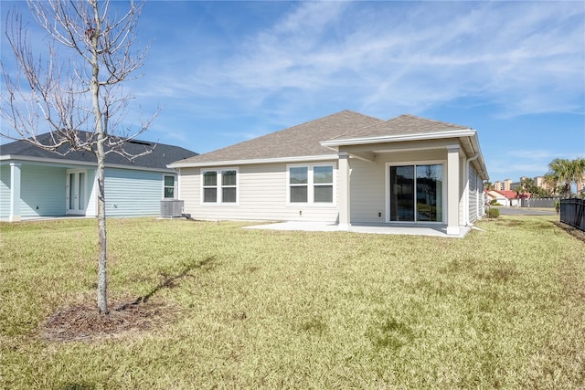 rear view of property with a yard, a patio area, and central air condition unit