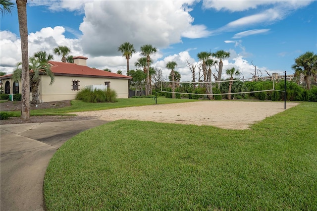 surrounding community with volleyball court and a lawn