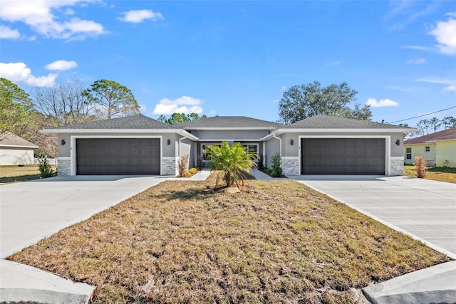 single story home featuring a garage and a front lawn