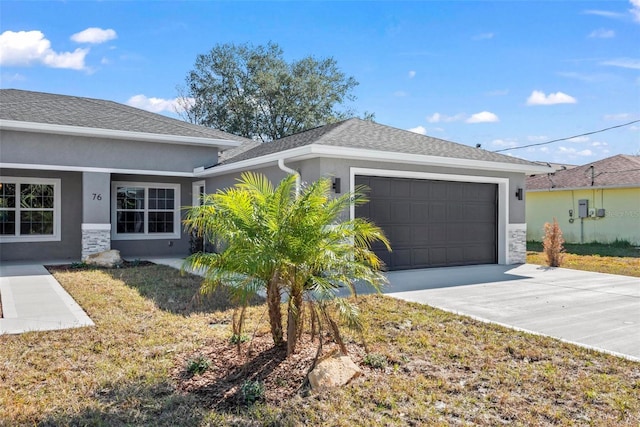 single story home with a garage and a front lawn