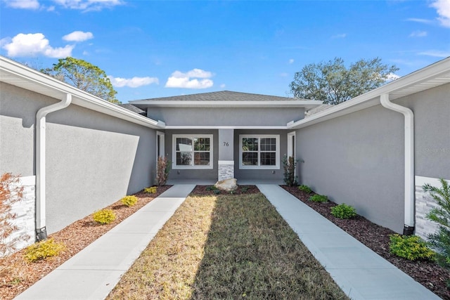 property entrance with a yard