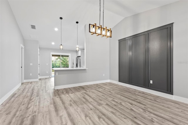 interior space featuring vaulted ceiling and light wood-type flooring