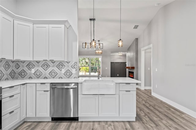 kitchen featuring sink, white cabinetry, decorative light fixtures, dishwasher, and decorative backsplash