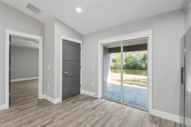 entryway featuring vaulted ceiling and light hardwood / wood-style floors