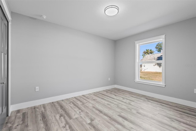 unfurnished bedroom featuring light hardwood / wood-style flooring and a closet