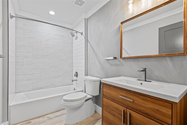 full bathroom with tiled shower / bath combo, vanity, wood-type flooring, ornamental molding, and toilet