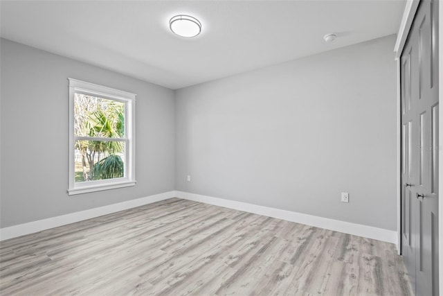 empty room with light hardwood / wood-style flooring