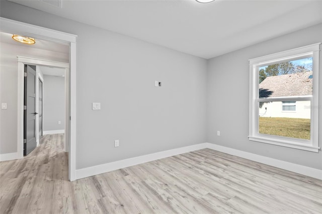 spare room with light hardwood / wood-style flooring