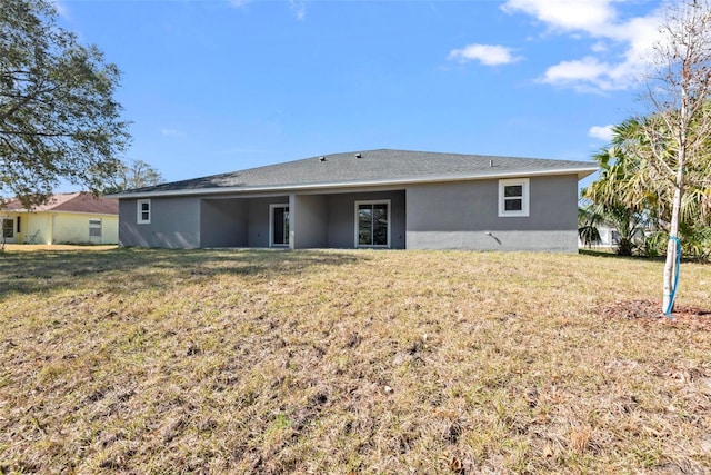 rear view of property with a yard