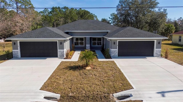 view of front of property featuring a garage and a front yard