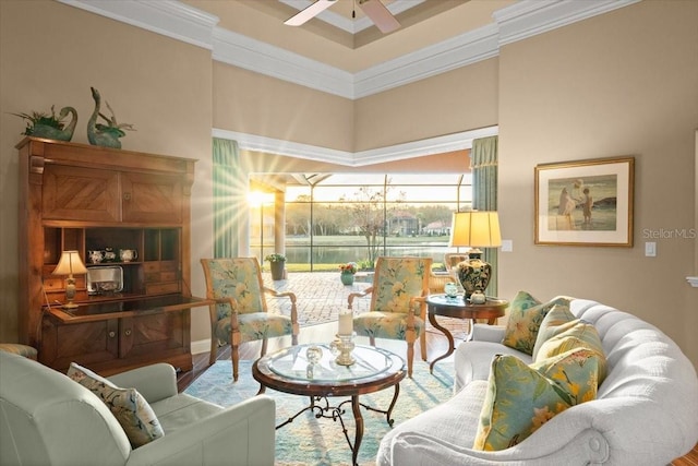 living area featuring ceiling fan, wood finished floors, and crown molding