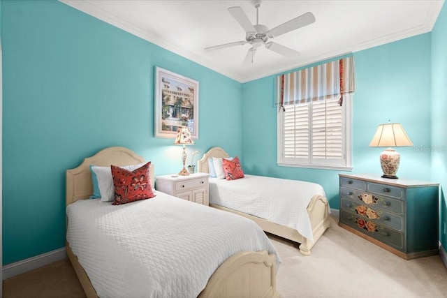 bedroom featuring carpet flooring, crown molding, baseboards, and ceiling fan