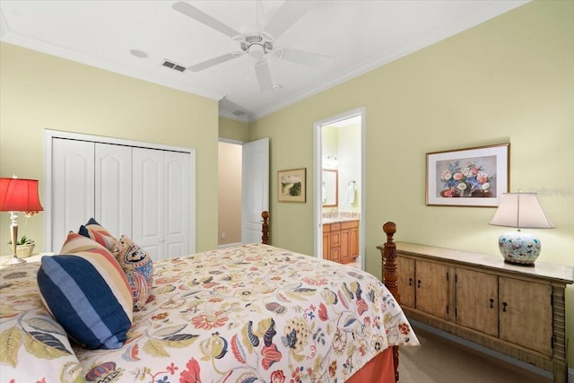 carpeted bedroom featuring visible vents, connected bathroom, ceiling fan, crown molding, and a closet