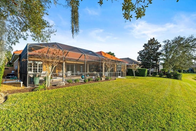 back of property featuring a lanai and a yard