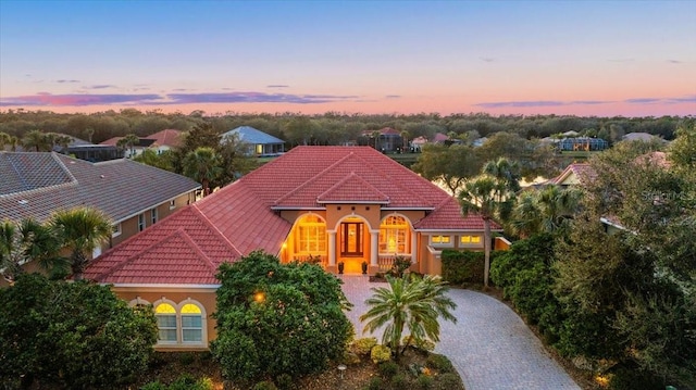 mediterranean / spanish home with driveway and a tiled roof