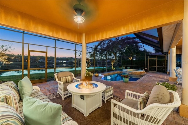 sunroom with a ceiling fan, lofted ceiling, and a water view