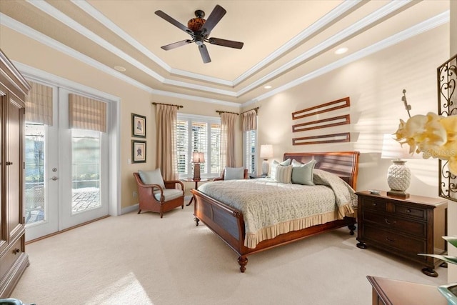 carpeted bedroom featuring a ceiling fan, access to exterior, ornamental molding, french doors, and a tray ceiling