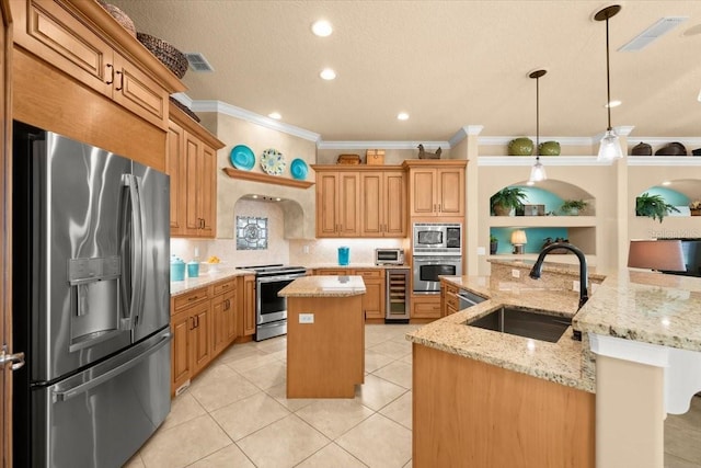 kitchen with beverage cooler, visible vents, a kitchen island with sink, stainless steel appliances, and a sink