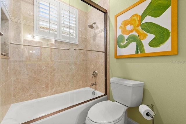 bathroom featuring tub / shower combination and toilet