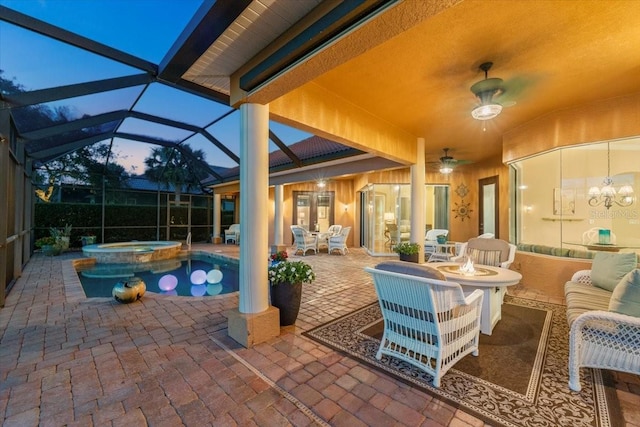 view of patio featuring ceiling fan, french doors, a lanai, and a pool with connected hot tub