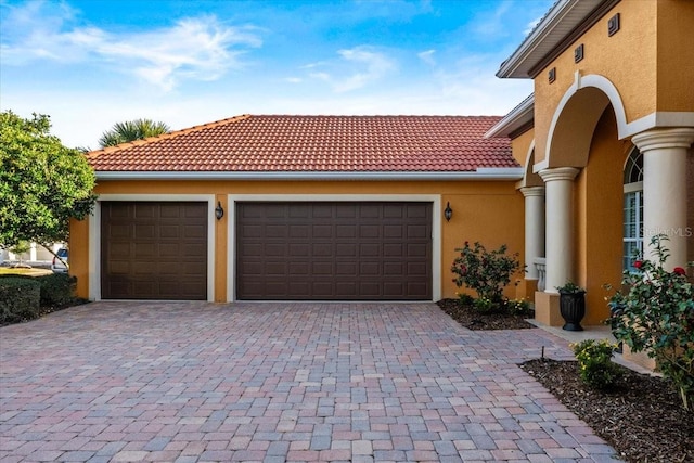 garage with decorative driveway