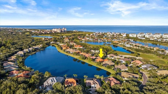 drone / aerial view featuring a water view and a residential view