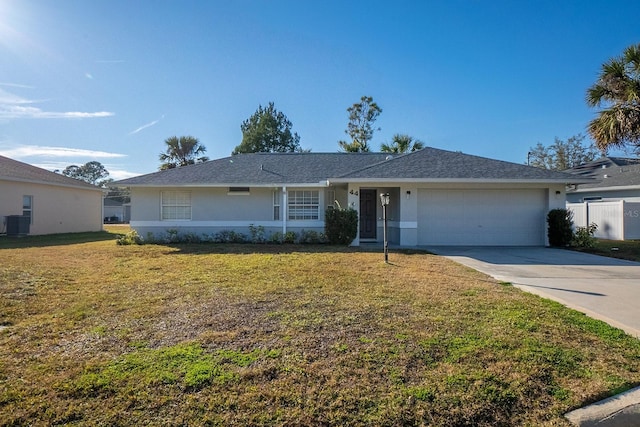 single story home with a garage, a front yard, and central air condition unit