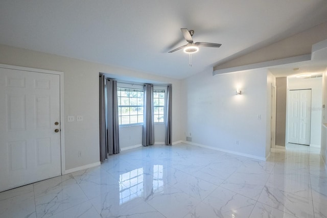 spare room featuring lofted ceiling and ceiling fan