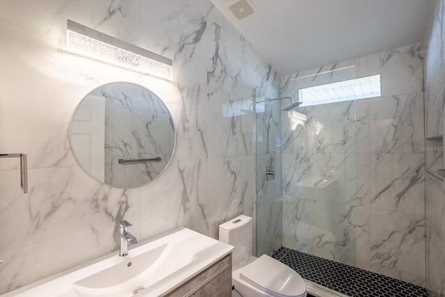 bathroom featuring vanity, decorative backsplash, a shower with door, and toilet