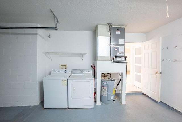 clothes washing area with washer and dryer and a textured ceiling