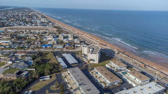 birds eye view of property featuring a water view and a view of the beach