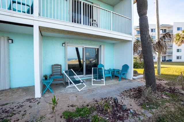 view of patio featuring a balcony