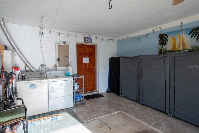 clothes washing area featuring laundry area, electric panel, and separate washer and dryer