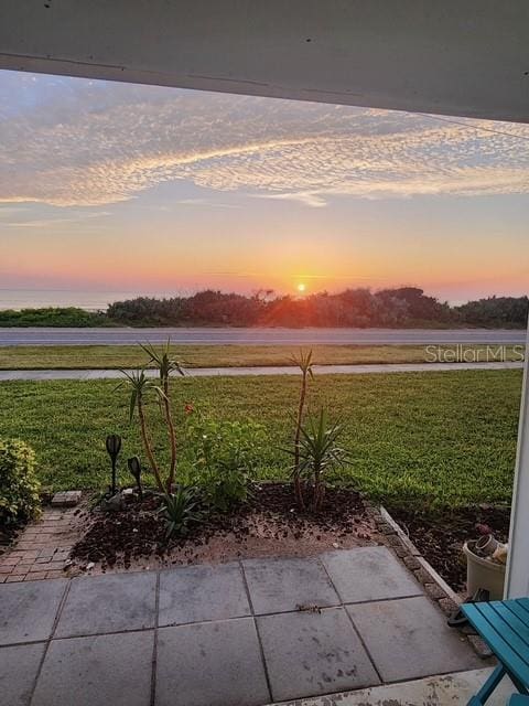 yard at dusk with a patio area