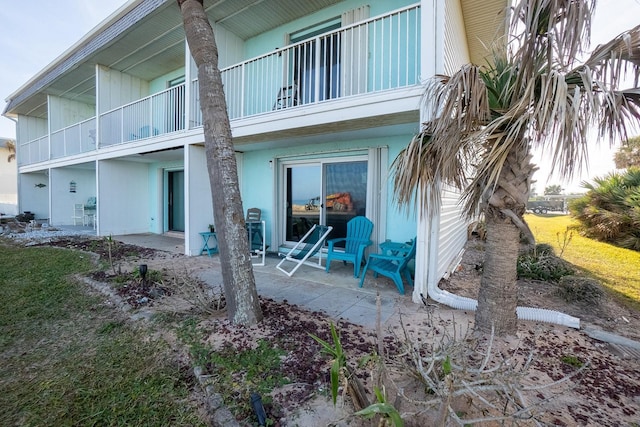 back of house featuring a patio area and a balcony