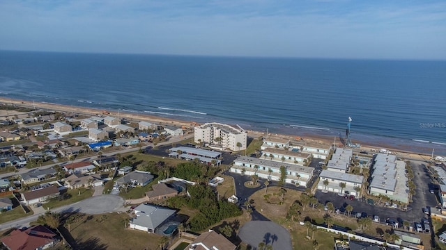 birds eye view of property with a beach view and a water view