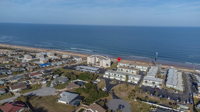 drone / aerial view featuring a water view and a view of the beach