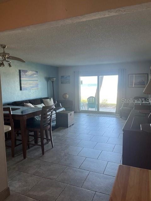 dining room with a textured ceiling and ceiling fan