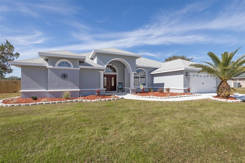 view of front of house with a garage and a front yard