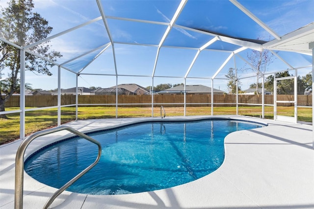 view of swimming pool featuring a yard, a patio, and glass enclosure