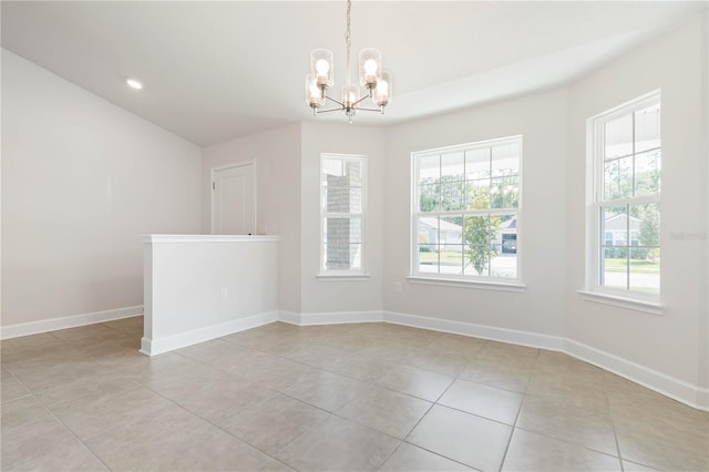 tiled empty room with a notable chandelier